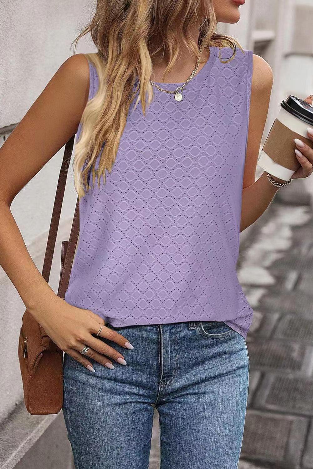 a woman in a purple top holding a cup of coffee