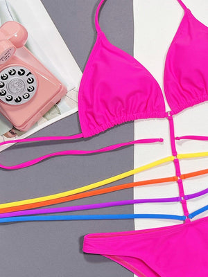 a pink phone, a pink bikini top, and a pair of multicolored