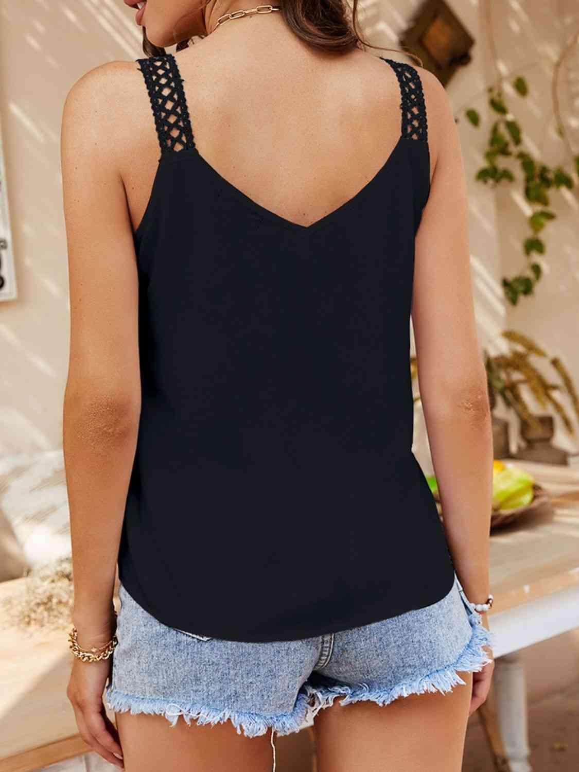 a woman wearing a black tank top with cut outs