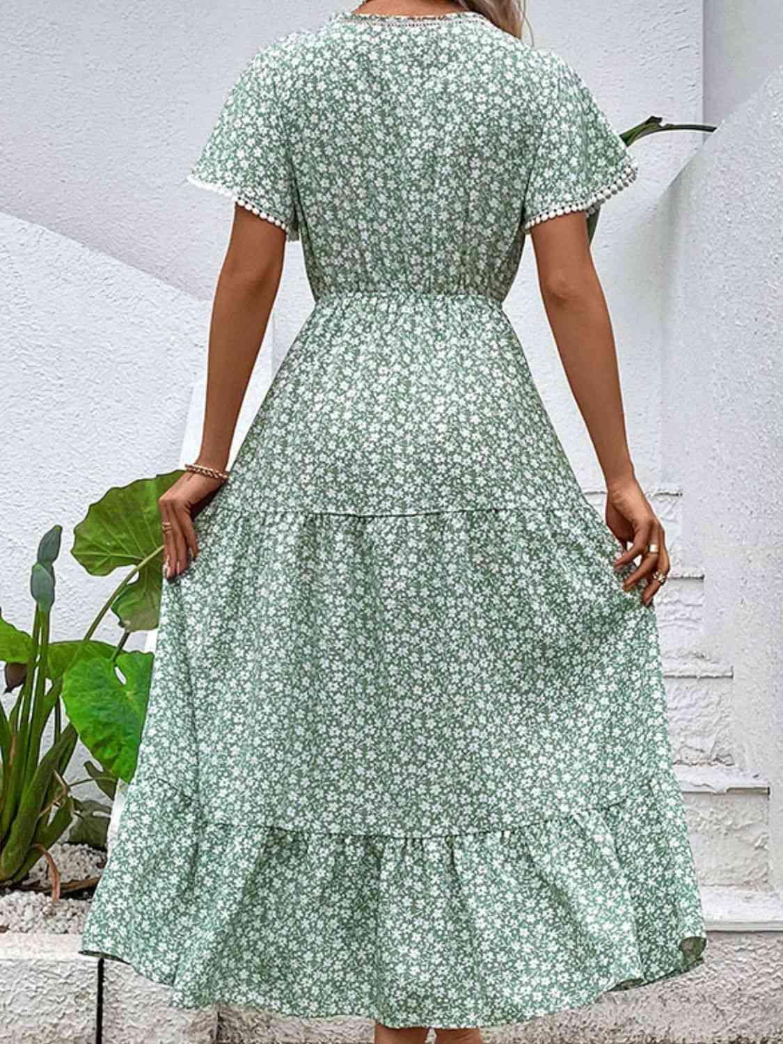 a woman in a green floral dress