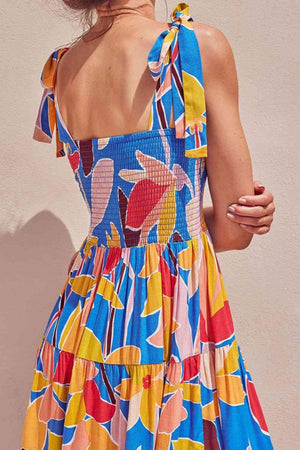 a woman in a colorful dress with a back cut out