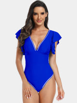 a woman in a blue one piece swimsuit