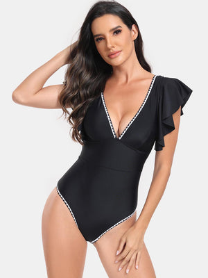 a woman in a black one piece swimsuit