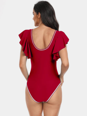 a woman wearing a red swimsuit with a frilling neckline