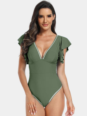 a woman in a green one piece swimsuit