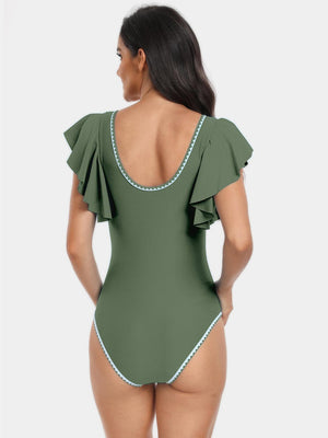 a woman in a green one piece swimsuit