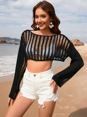 a woman standing on top of a beach next to the ocean