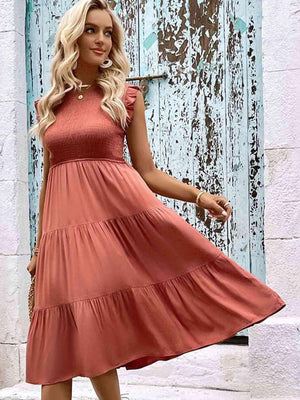 a woman in a pink dress standing in front of a door