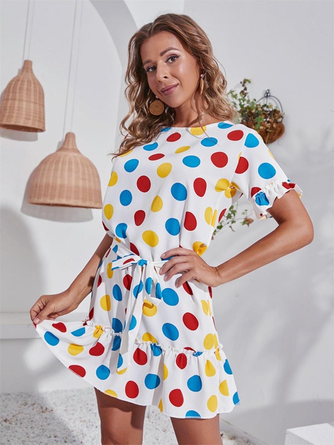 a woman in a polka dot dress posing for a picture