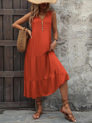 a woman in an orange dress and straw hat