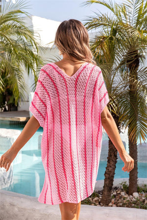 a woman in a pink and white knitted cover up by a pool