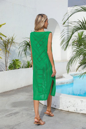 a woman standing in front of a pool wearing a green dress