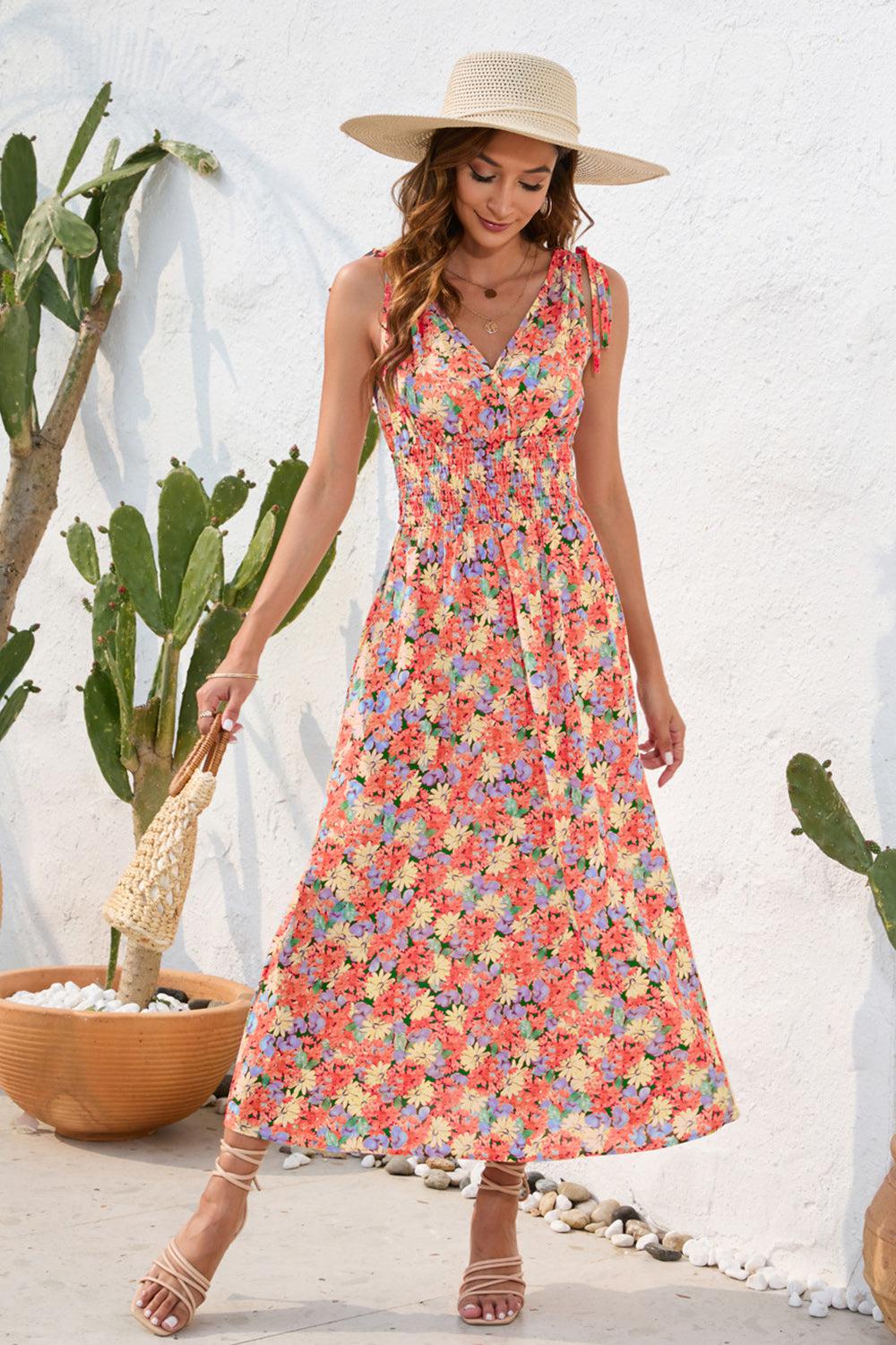 a woman in a dress and hat standing in front of a cactus