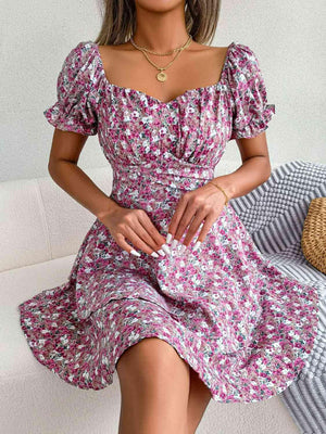 a woman sitting on a couch wearing a dress