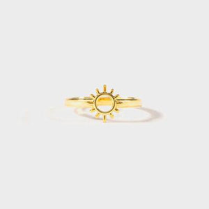 a gold ring with a sun on it