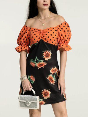 a woman wearing a dress with sunflowers on it