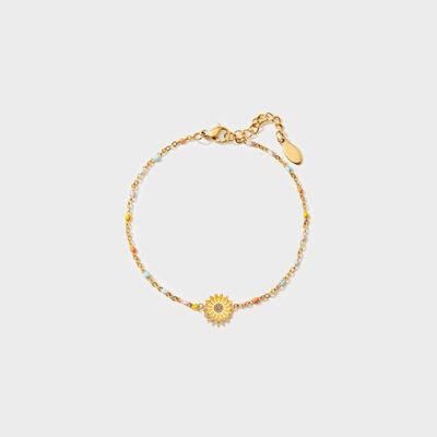 a gold bracelet with a flower charm