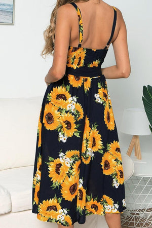 a woman wearing a sunflower print dress