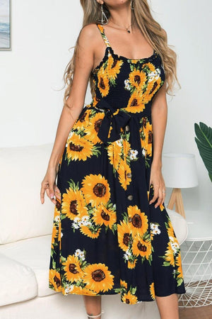 a woman wearing a sunflower print dress