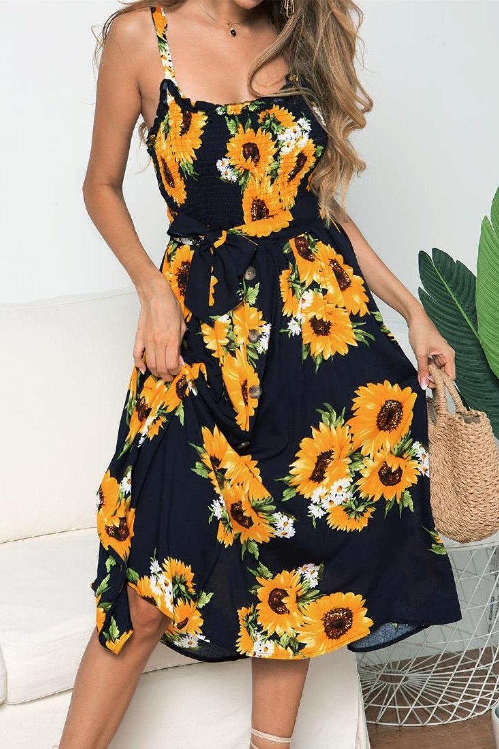 a woman wearing a sunflower print dress