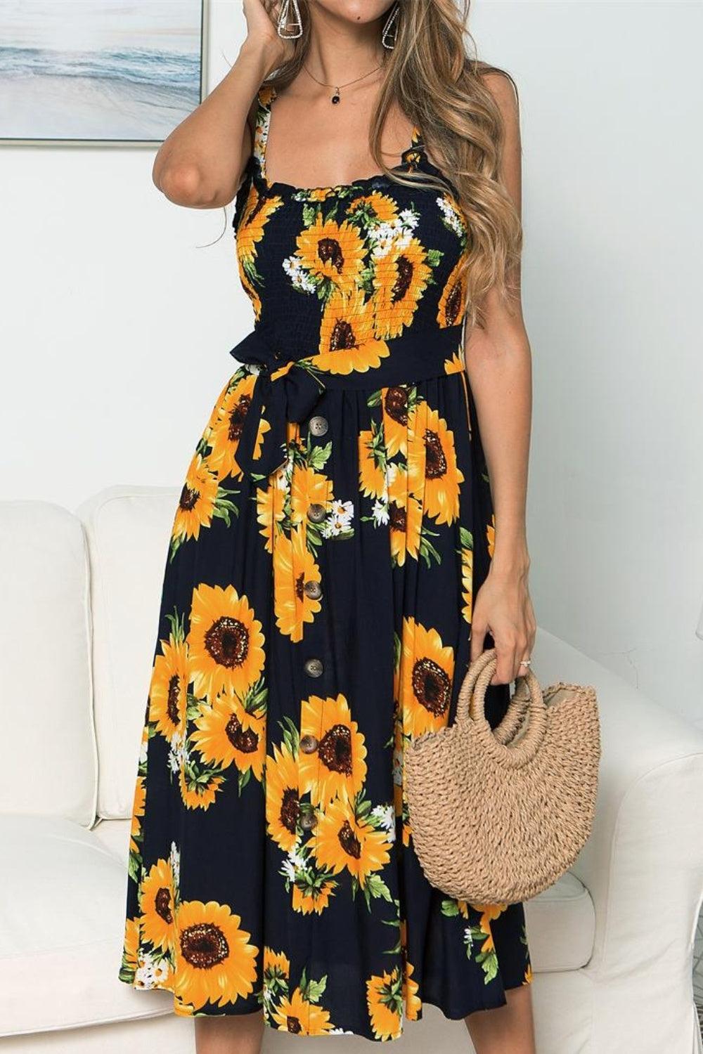 a woman wearing a sunflower print dress