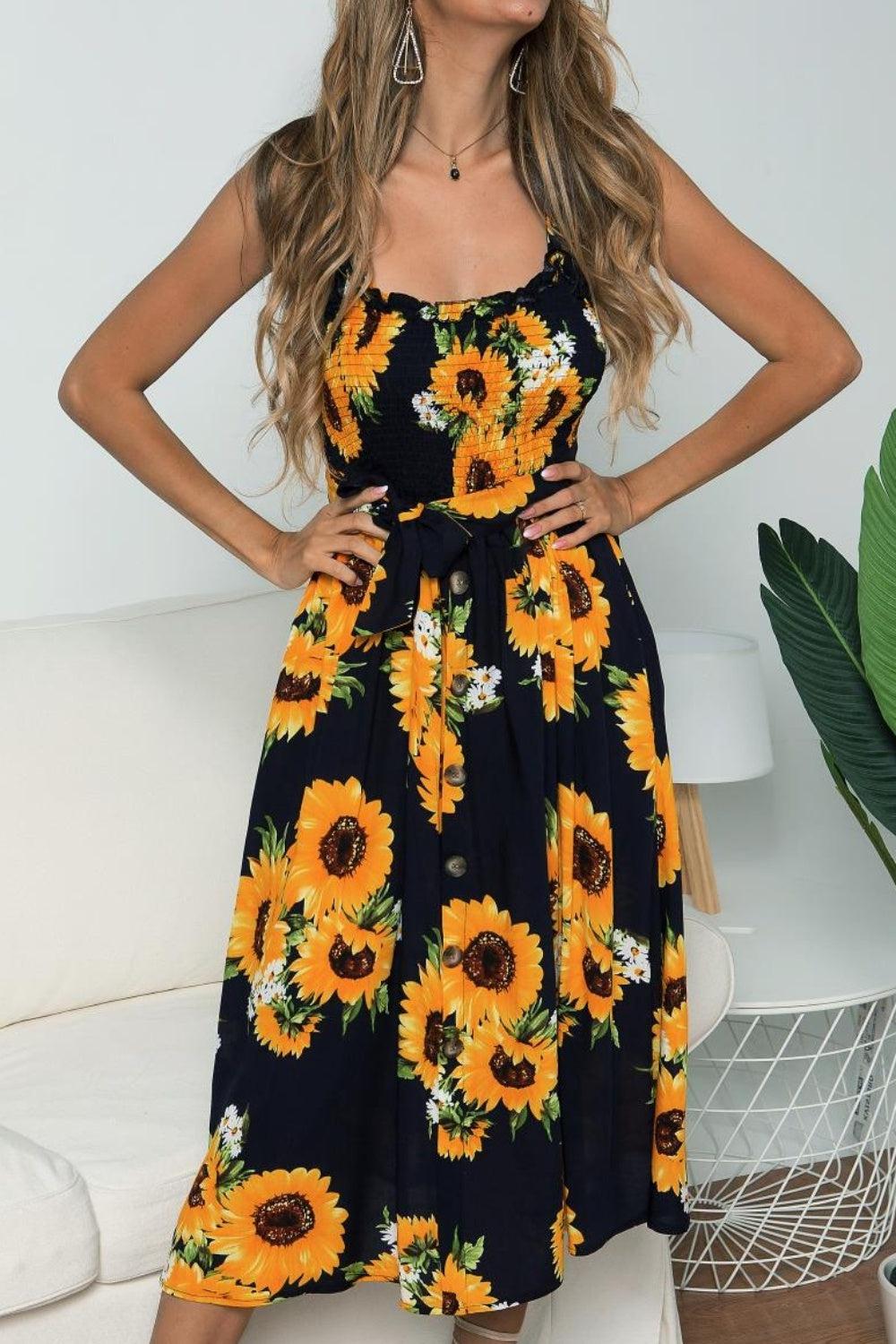 a woman wearing a sunflower print dress