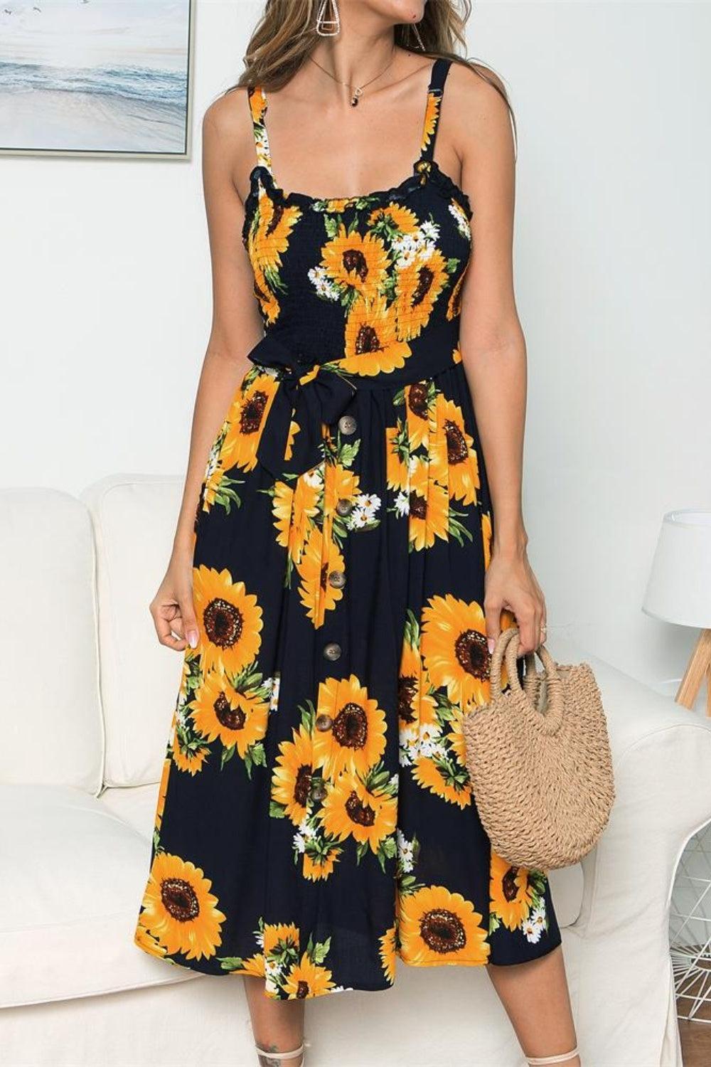 a woman wearing a sunflower print dress