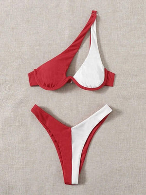 two red and white bikinis on a beige surface