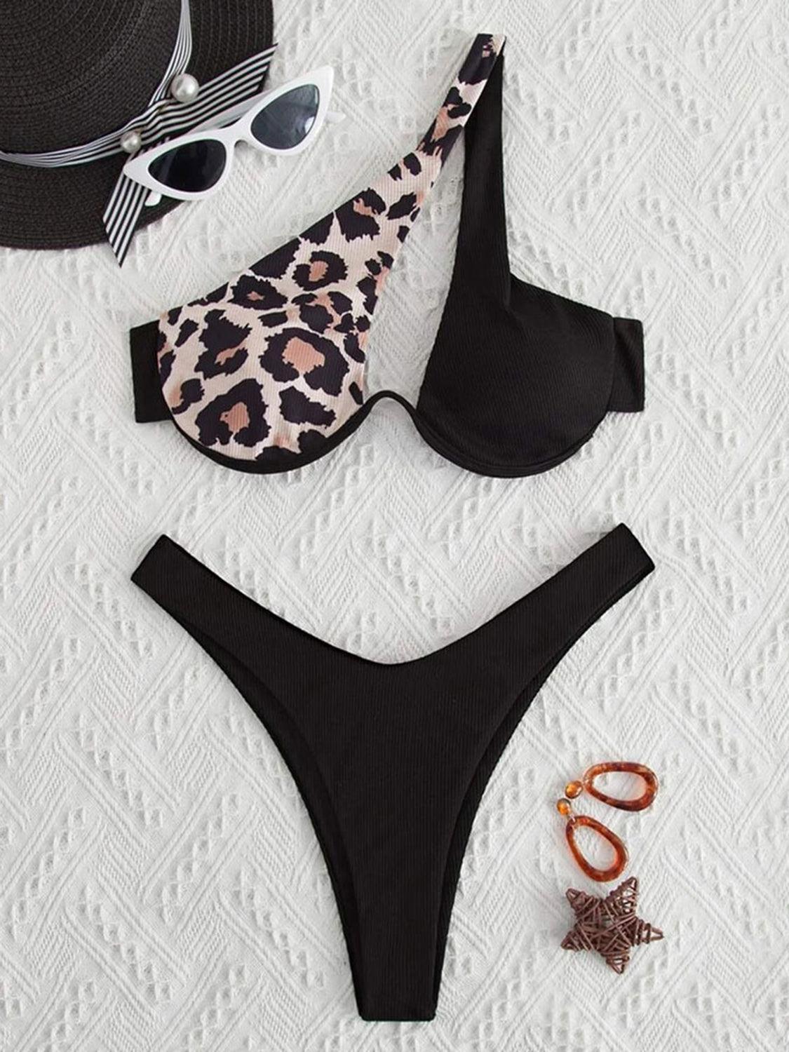 a bikini top, hat, sunglasses, and starfish on a bed