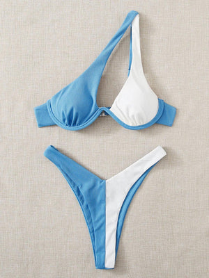 two blue and white bikinis on a beige surface