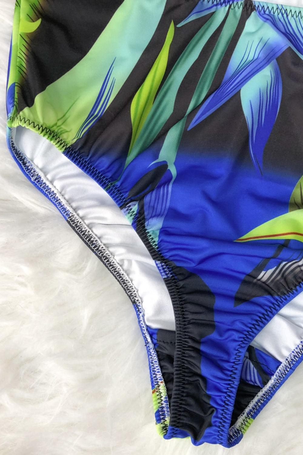 a women's swimsuit with a tropical print