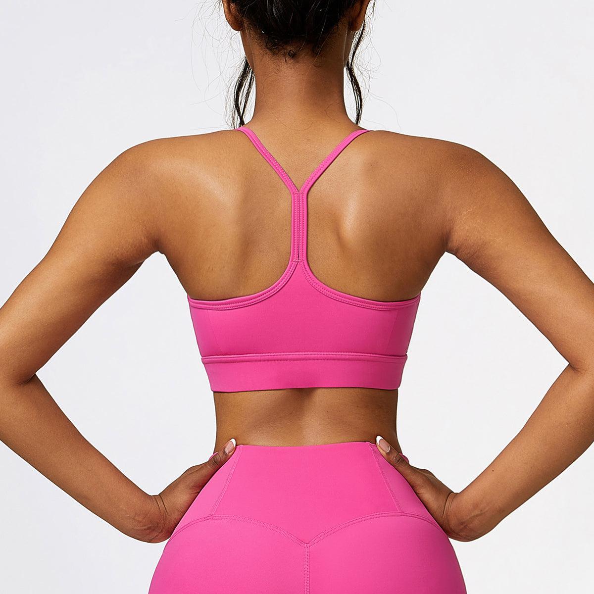 the back of a woman in a pink sports bra top