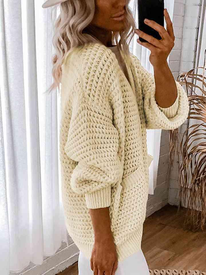 a woman taking a selfie in a white sweater