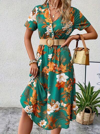 a woman wearing a green floral print dress