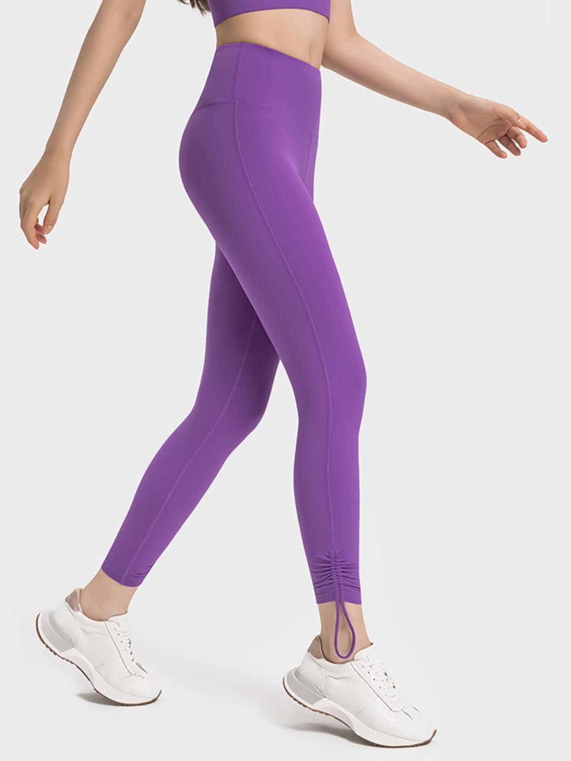 a woman in a purple sports bra top and leggings