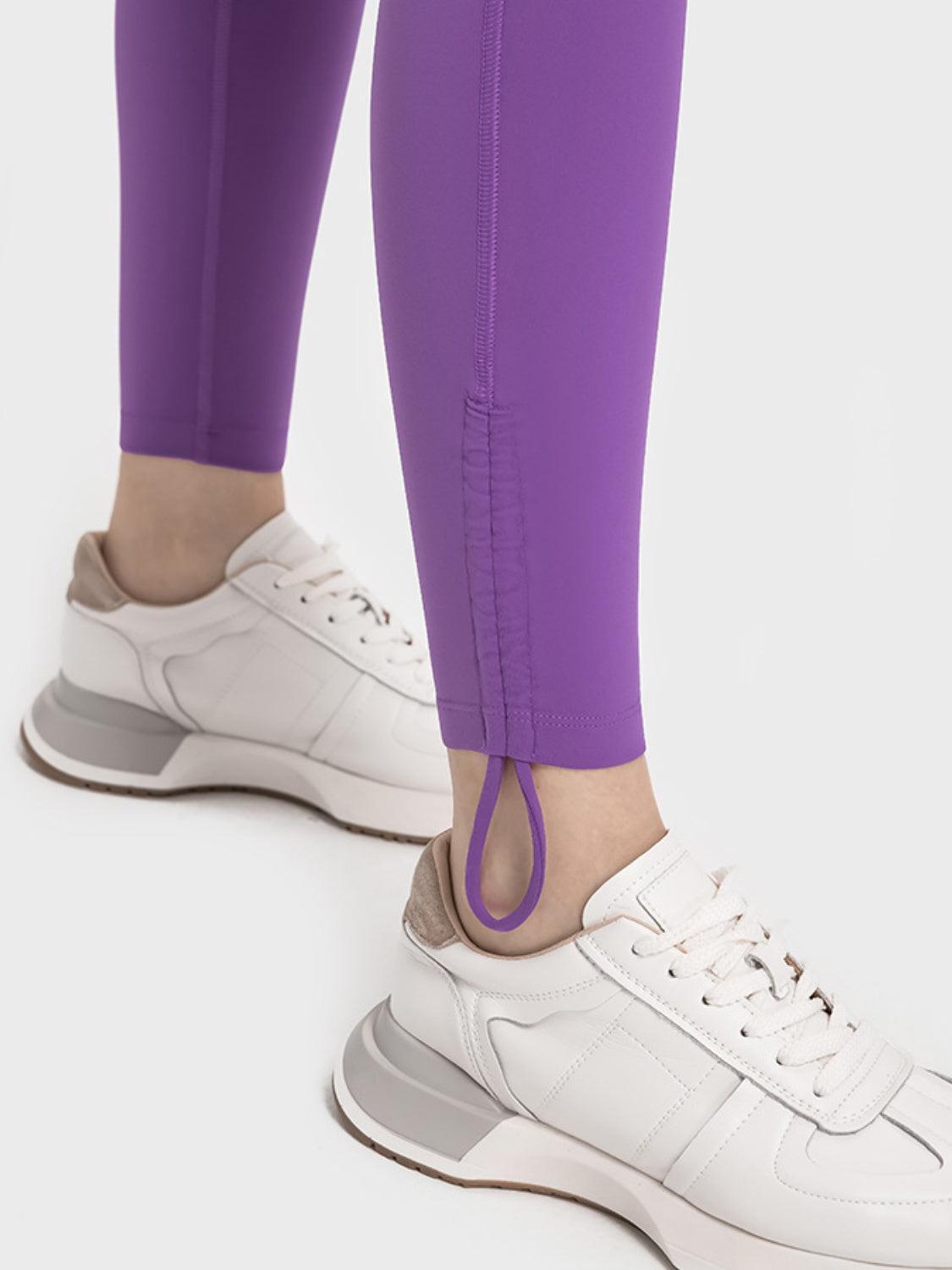 a person wearing purple pants and white sneakers