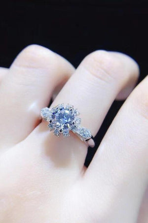 a close up of a person's hand with a ring on it