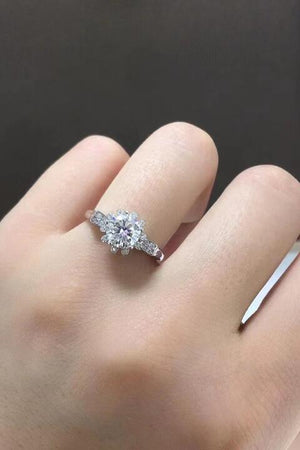 a woman's hand with a diamond ring on it