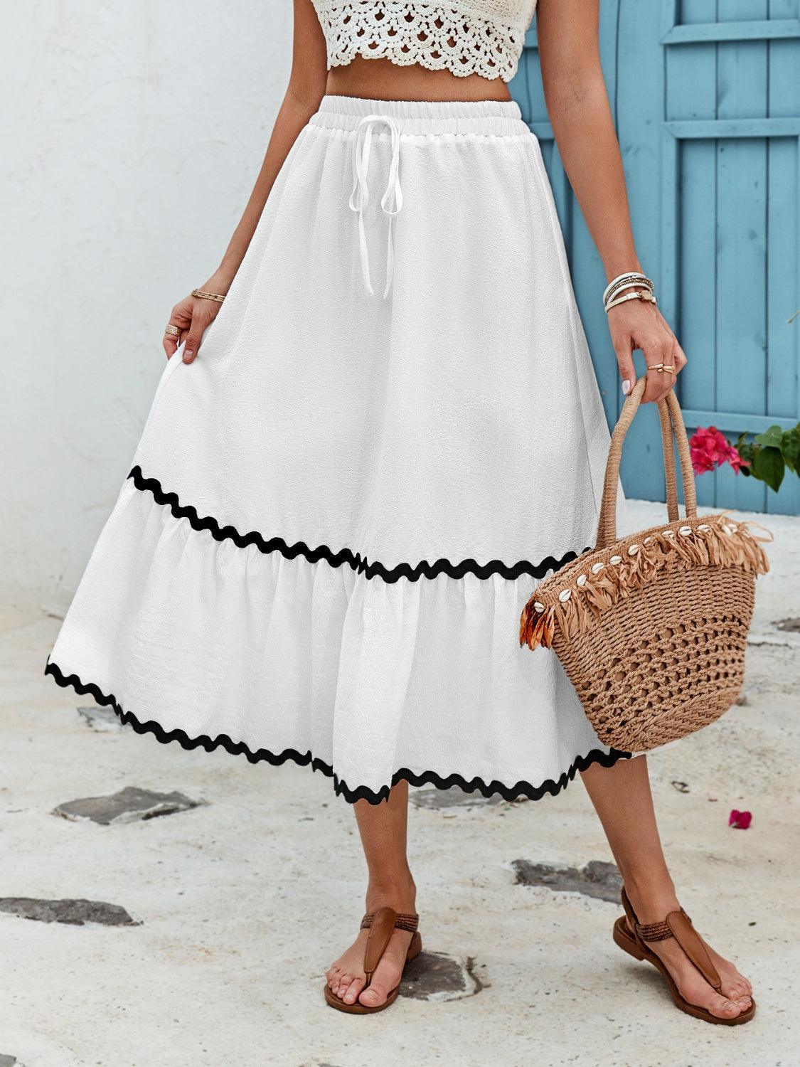 a woman in a white dress holding a wicker basket