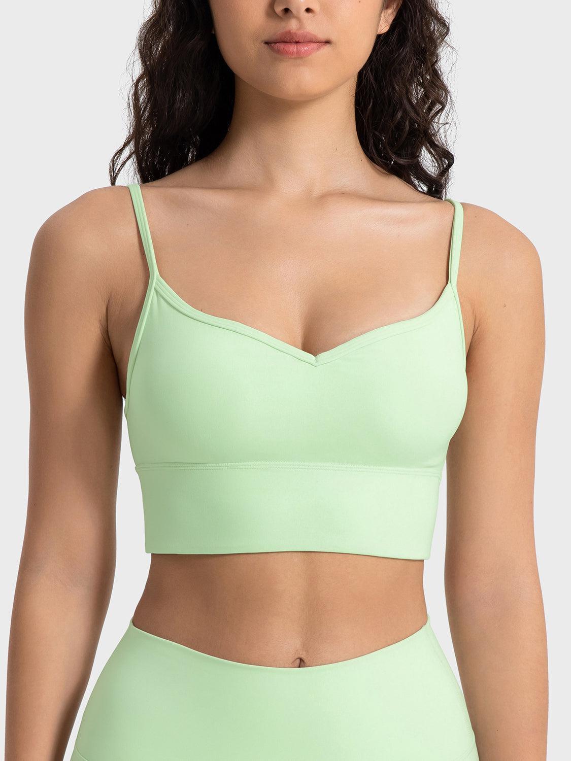 a woman wearing a light green bra top