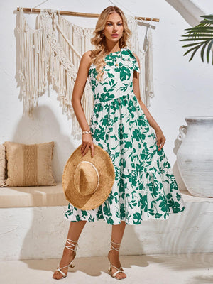 a woman in a green and white dress holding a straw hat