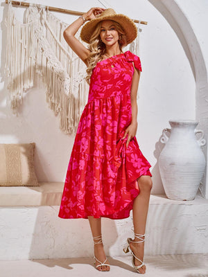 a woman in a red dress and straw hat