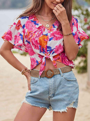 a woman standing on a beach with her hands in her pockets