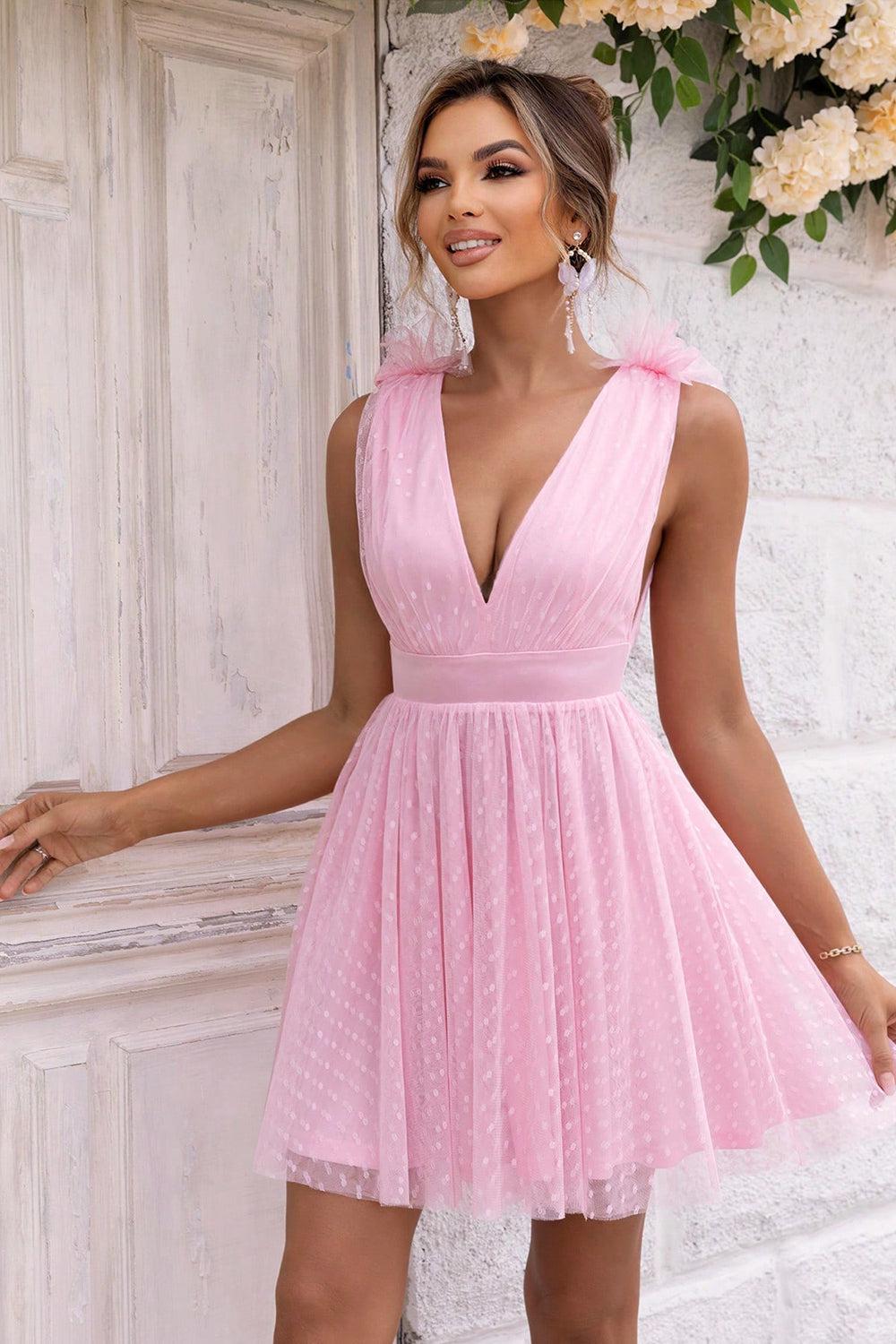 a woman in a pink dress posing for a picture