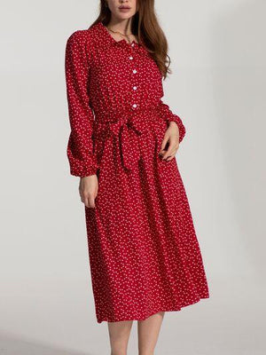 a woman wearing a red polka dot dress