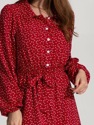 a woman wearing a red polka dot dress