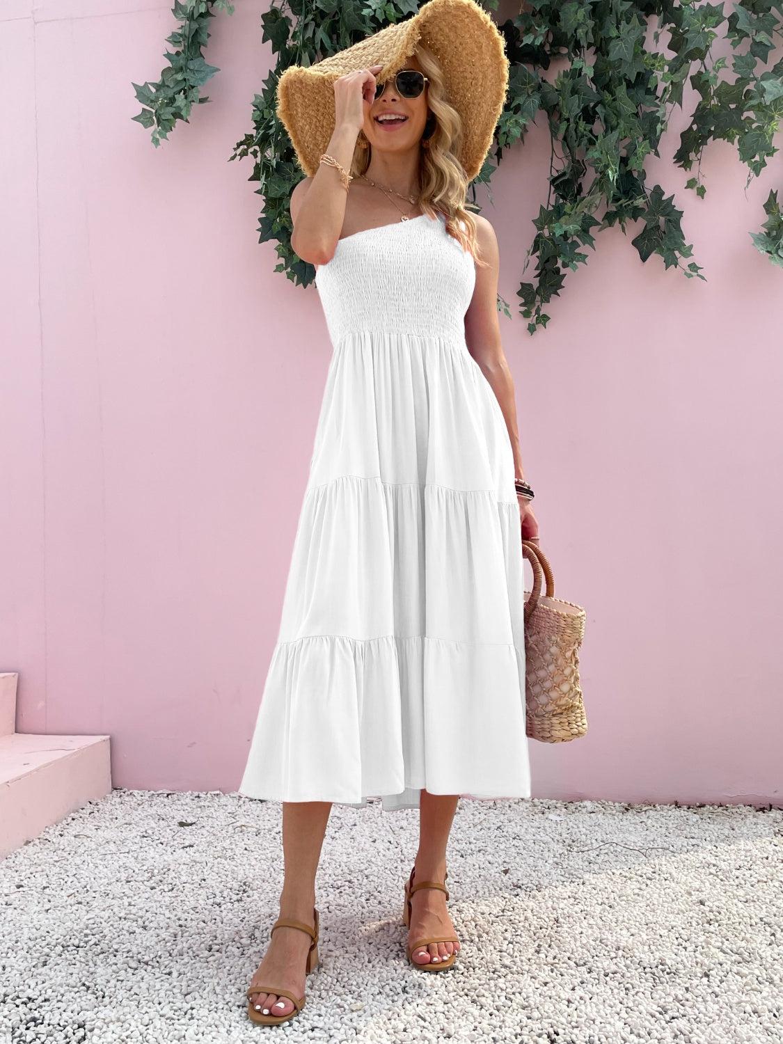 a woman wearing a white dress and straw hat