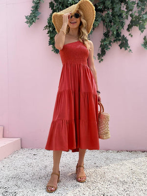 a woman wearing a red dress and a straw hat