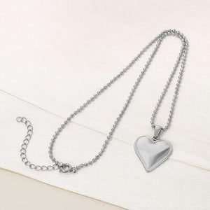 a heart shaped pendant on a chain
