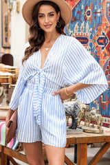 a woman wearing a blue and white striped romper